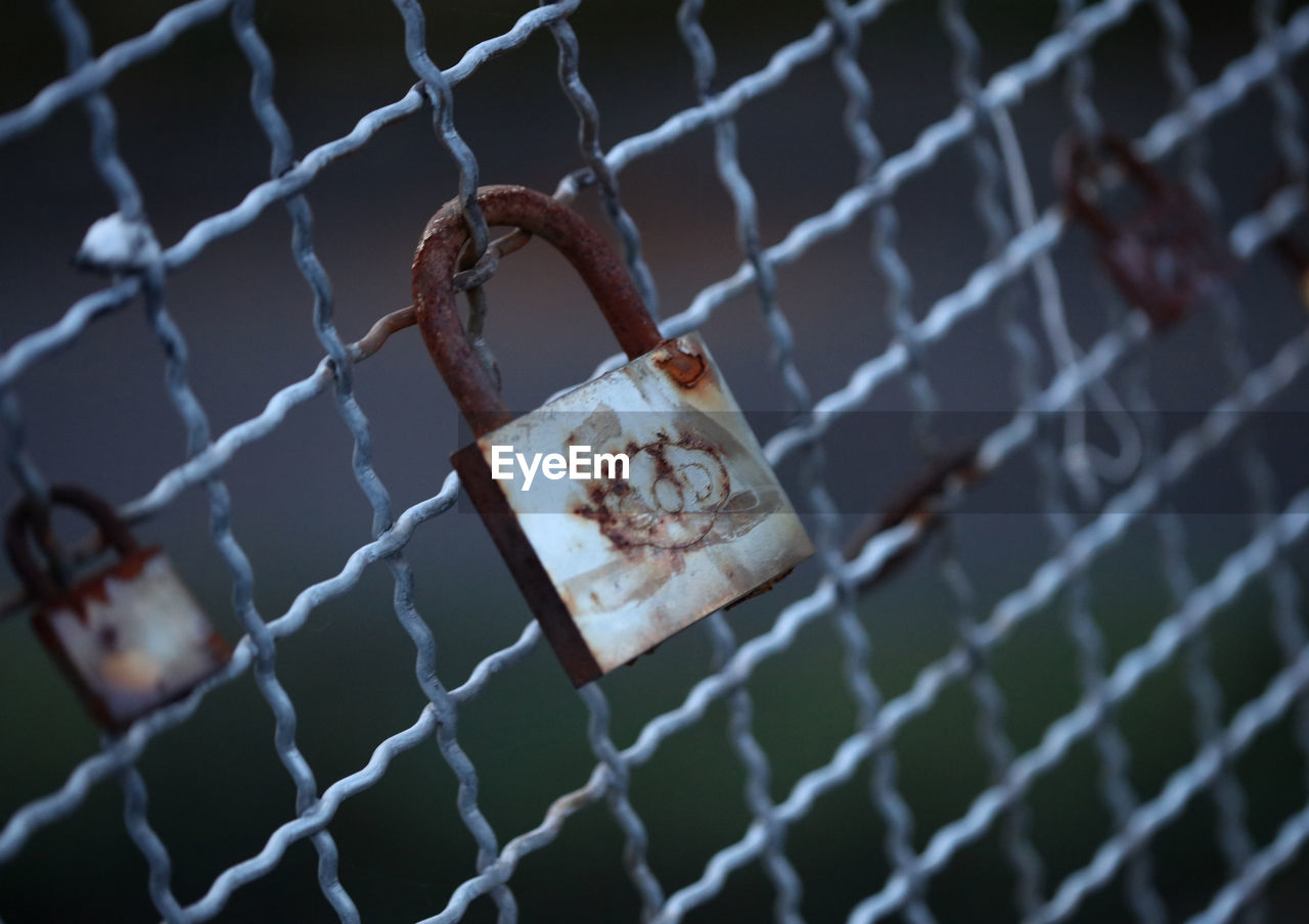 fence, chainlink fence, protection, security, padlock, metal, blue, no people, focus on foreground, lock, close-up, light, hanging, outdoors, emotion, day, macro photography, selective focus, nature, sports, wire mesh