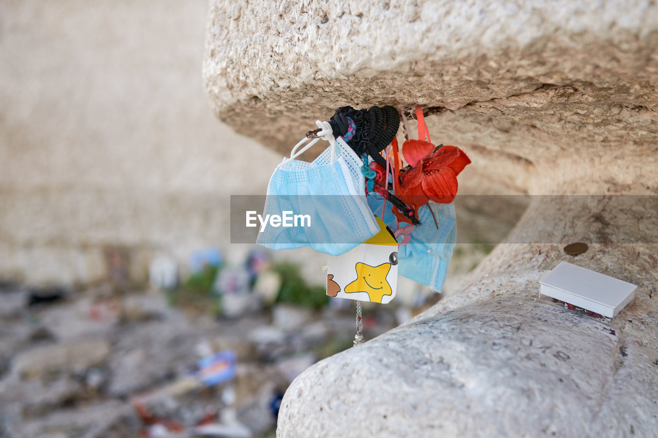 Medical mask, various object left as memory near the statue of christ the redeemer in maratea