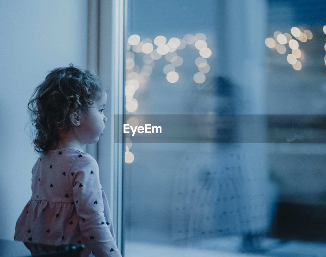 Cute girl looking out of window