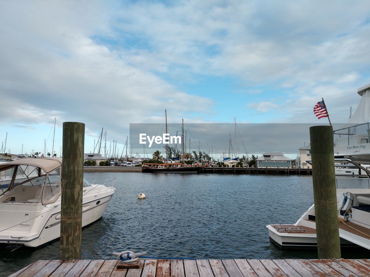 SAILBOATS MOORED AT HARBOR