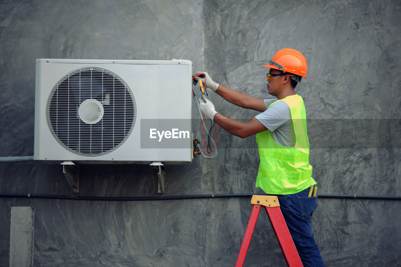 Man repairing air conditioner