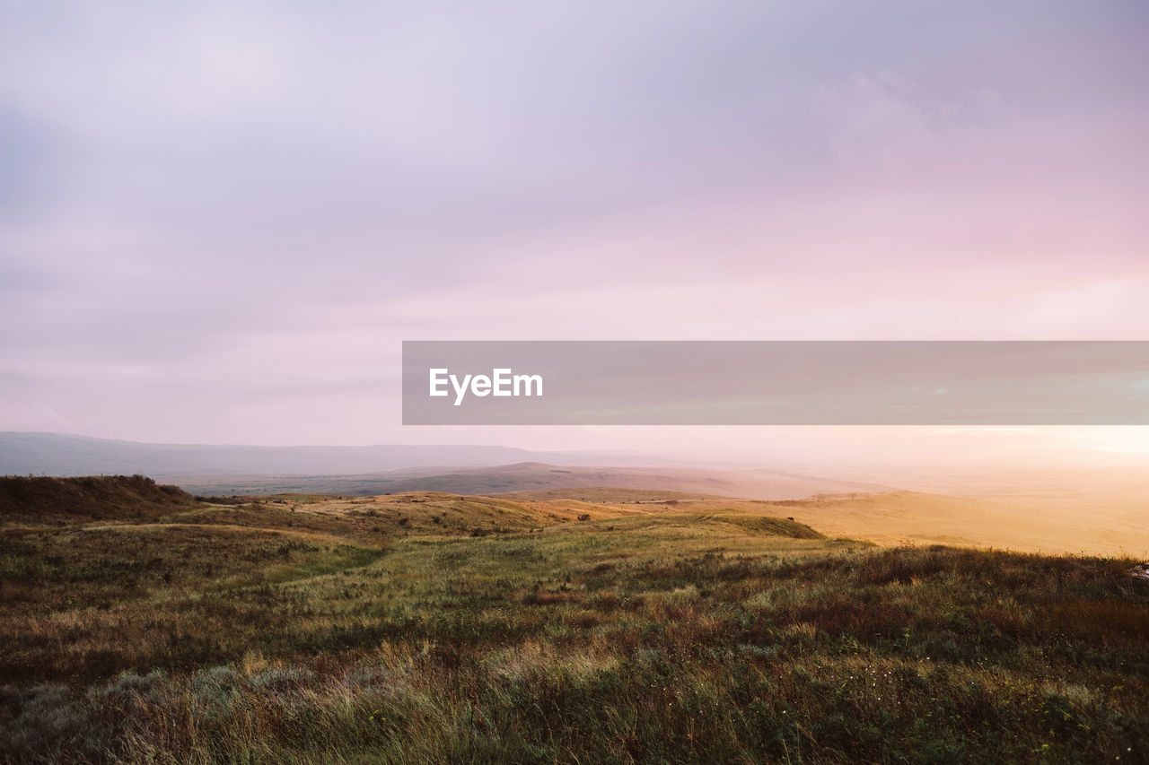 Scenic view of landscape against sky during sunset