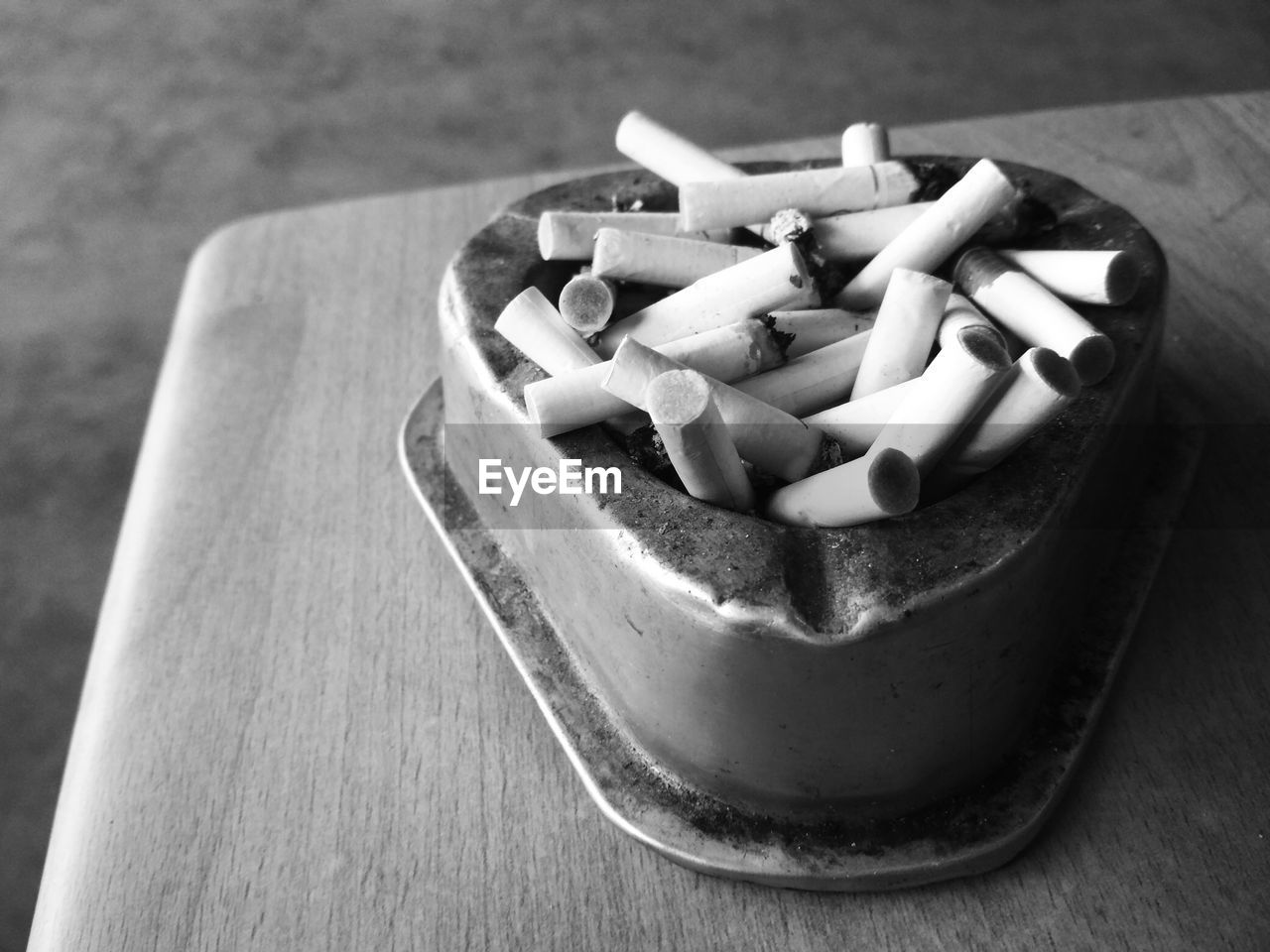 High angle view of cigarette butts in container