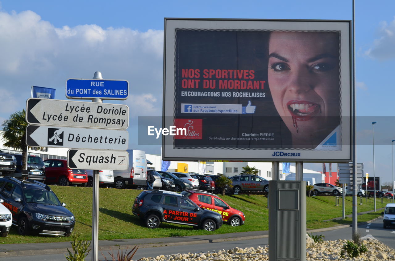 PEOPLE ON ROAD AGAINST SKY