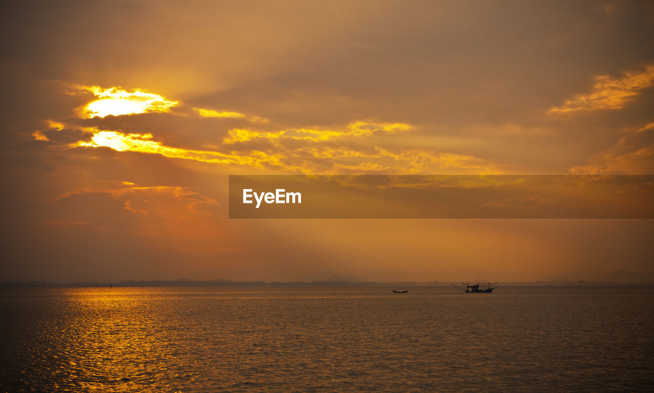 Scenic view of calm sea at sunset