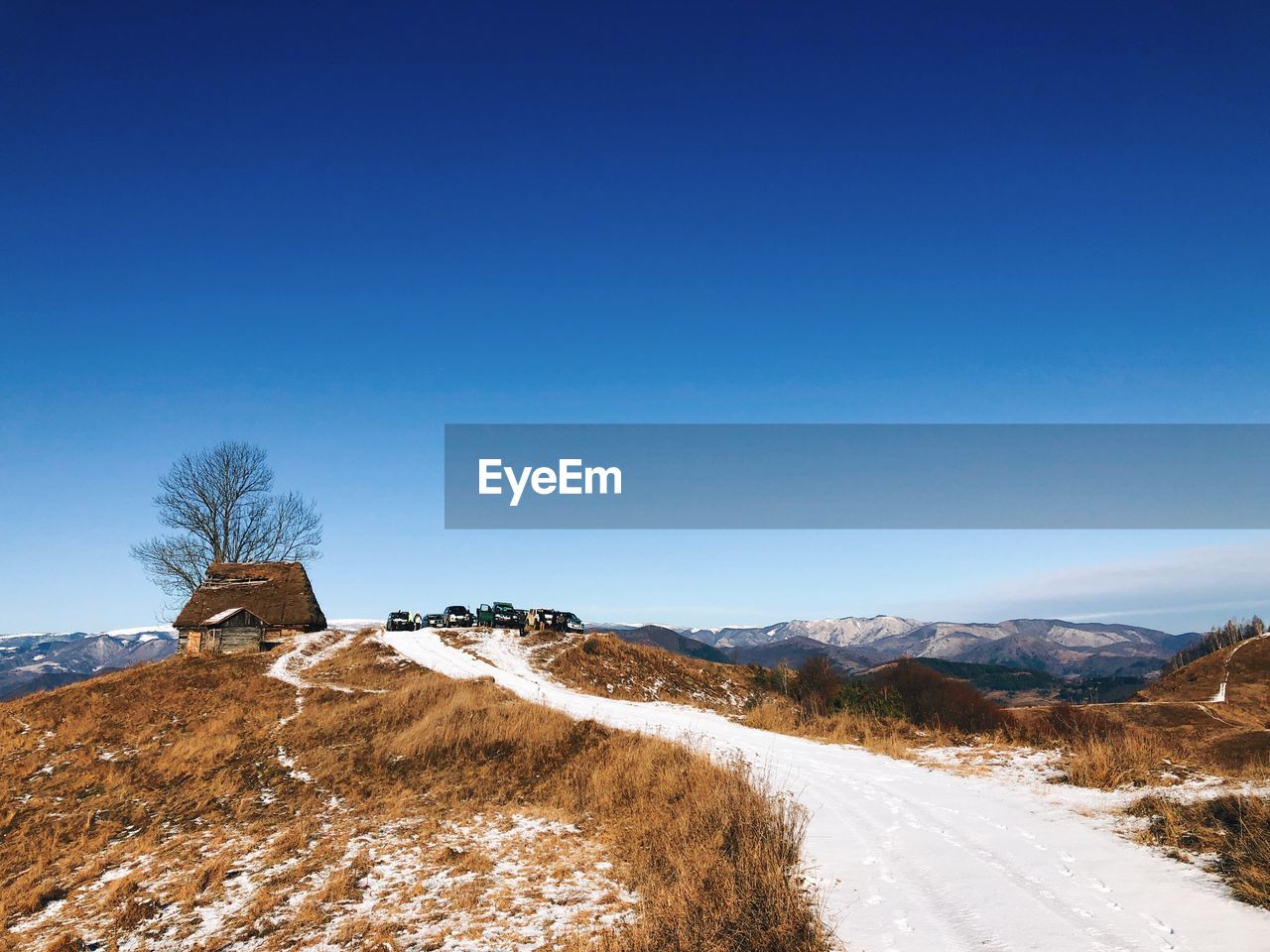 Scenic view of snowcapped mountains against clear blue sky