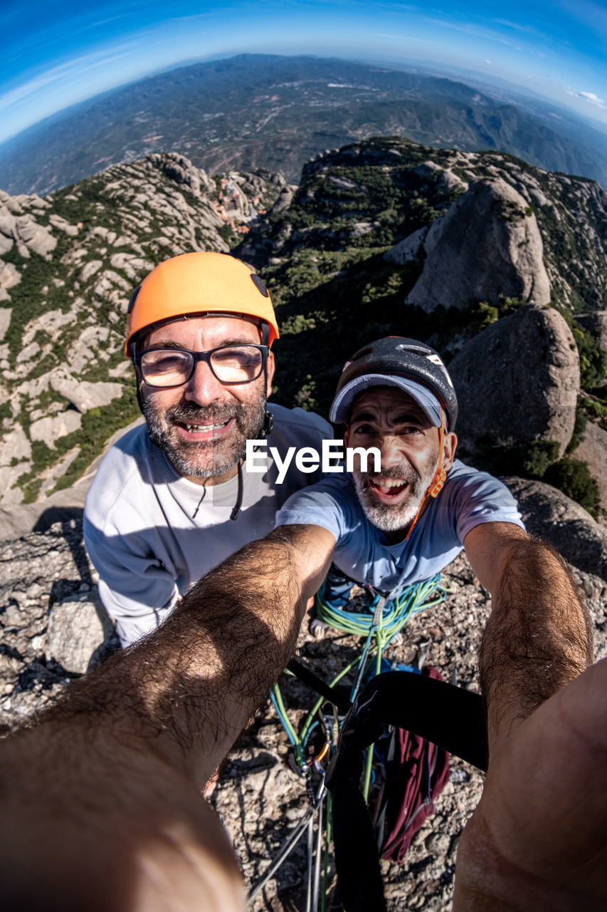 Selfie of two climber on peak of montserrat mountain