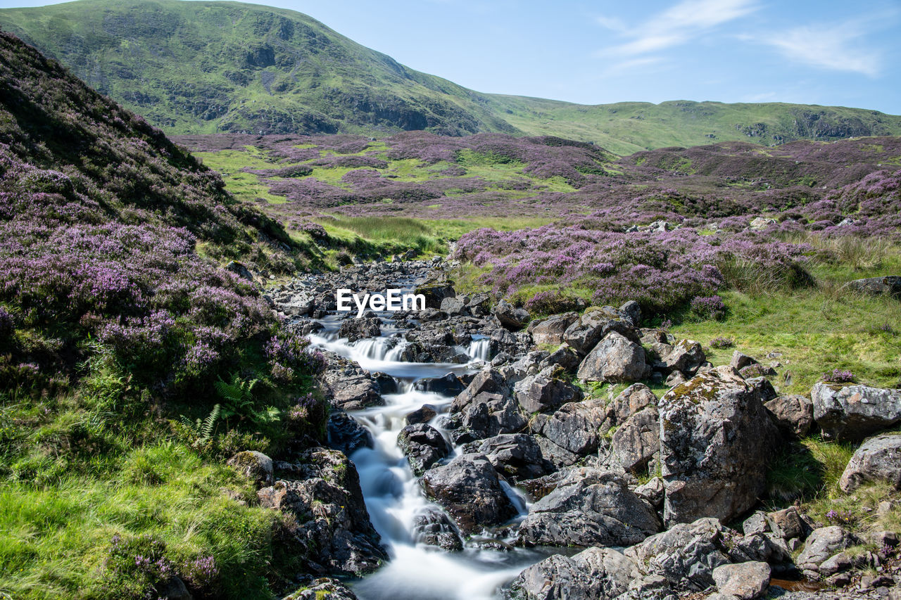 SCENIC VIEW OF STREAM FLOWING THROUGH ROCKS