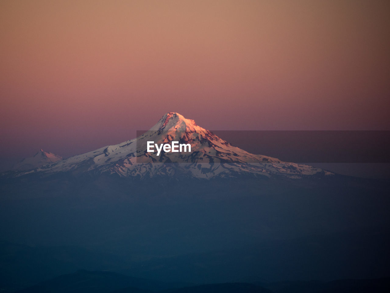 Scenic view of snowcapped mountain against sky at night