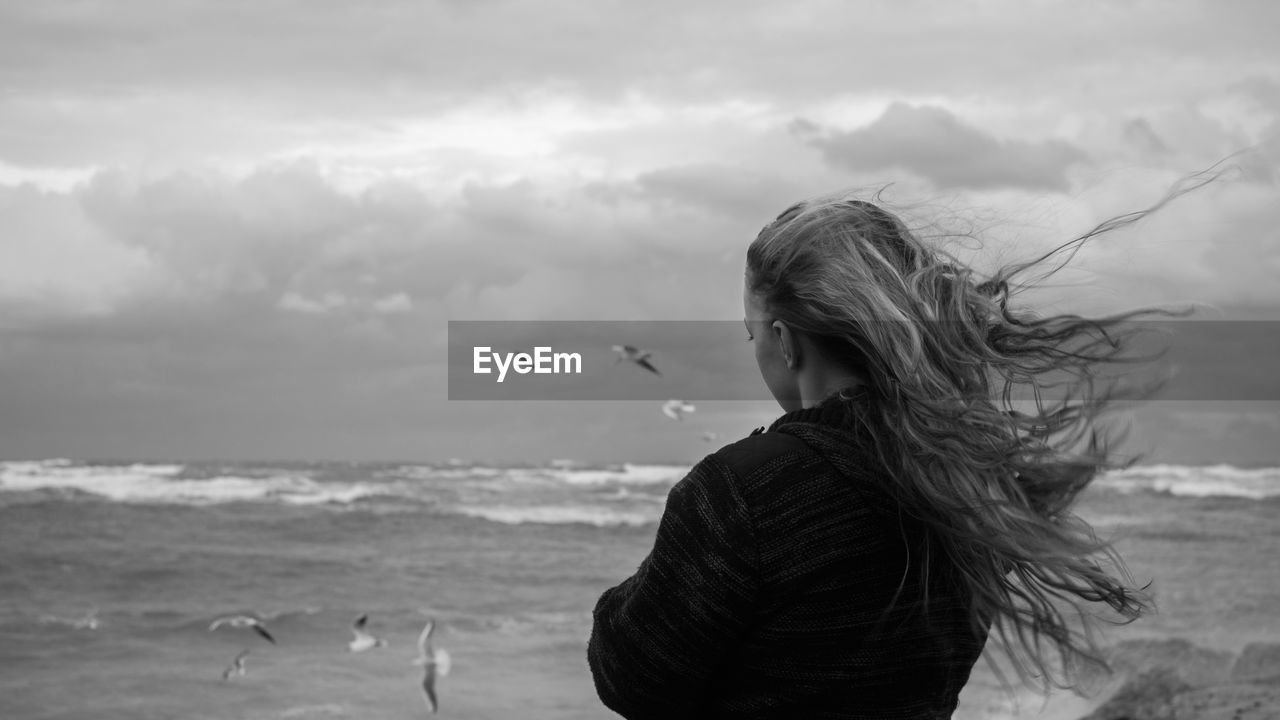 Teenage girl looking at sea