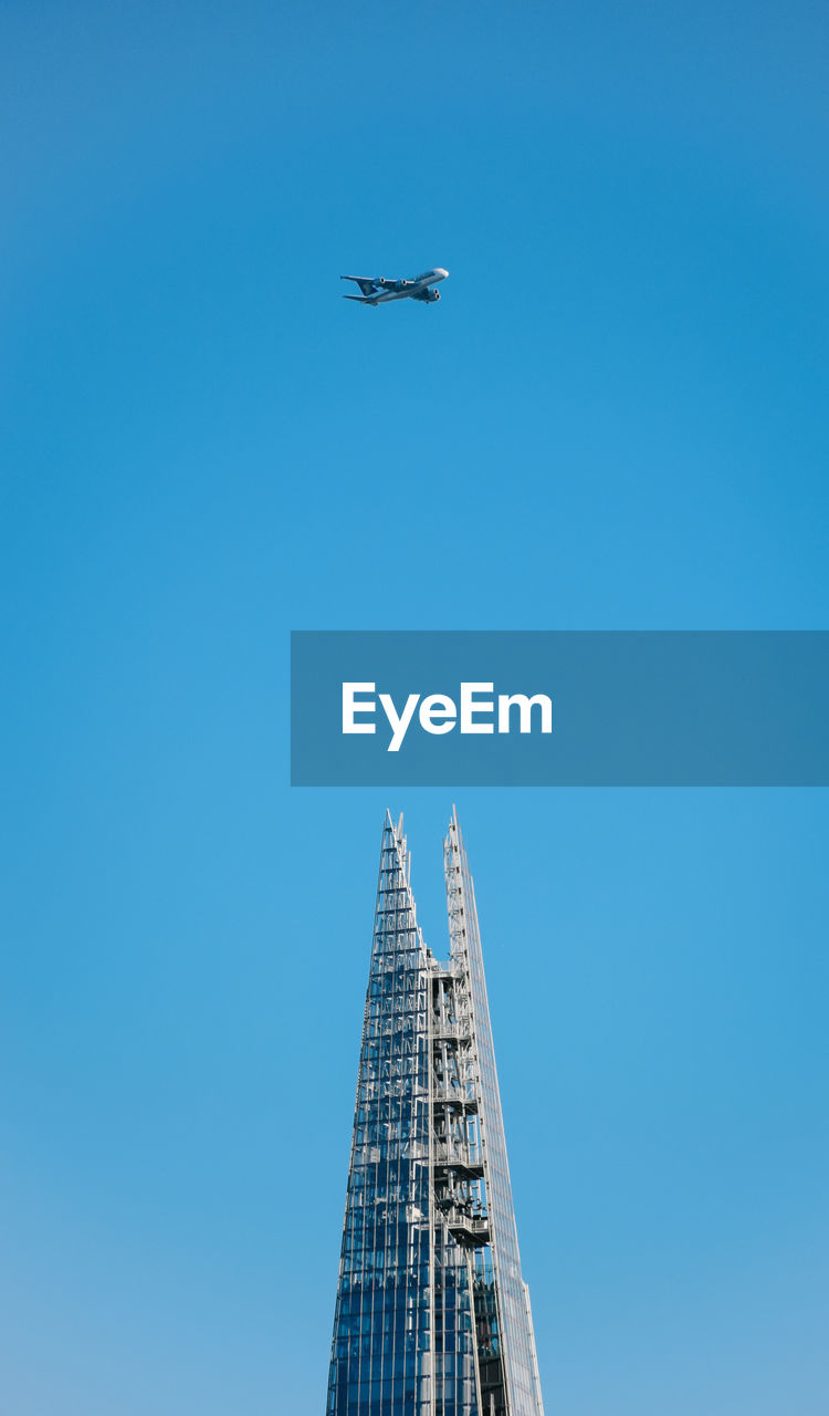 LOW ANGLE VIEW OF AIRPLANE FLYING IN CLEAR SKY