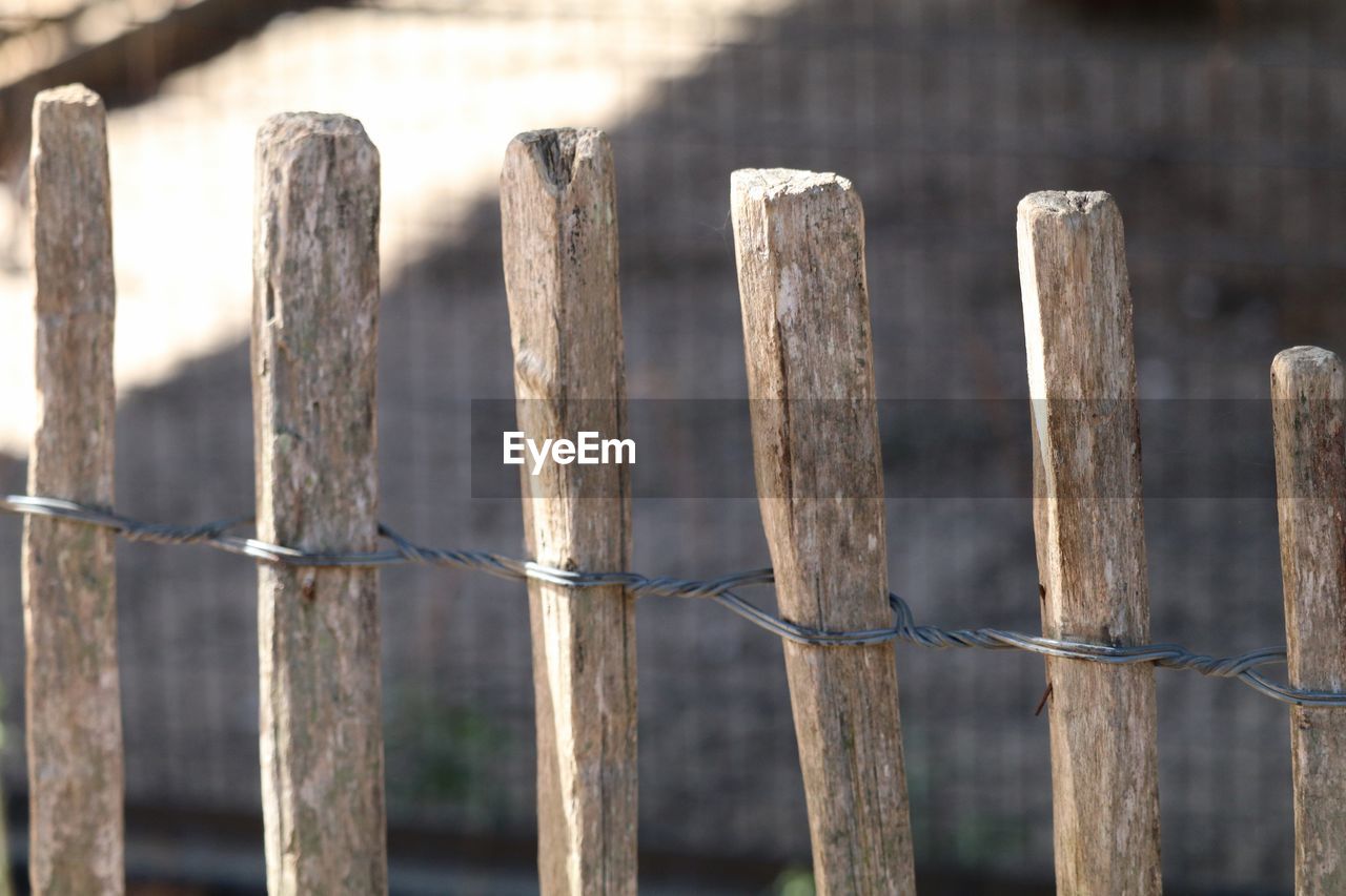 Wooden fence tied with metal wire