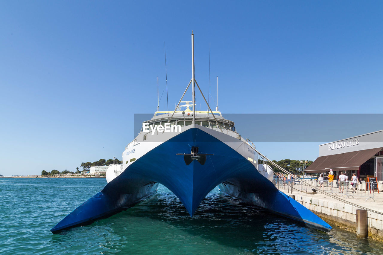 SHIP IN WATER AGAINST BLUE SKY