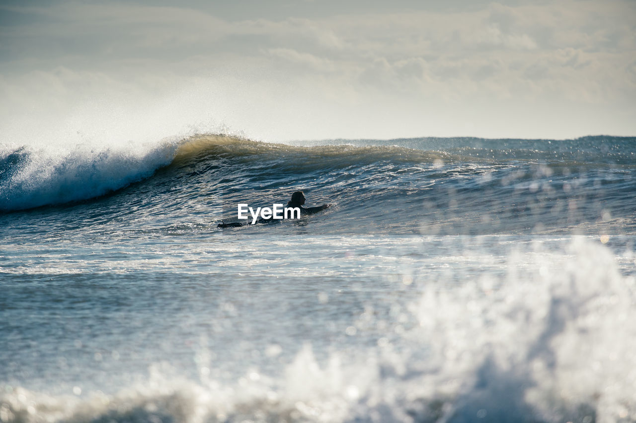 MAN SURFING IN SEA