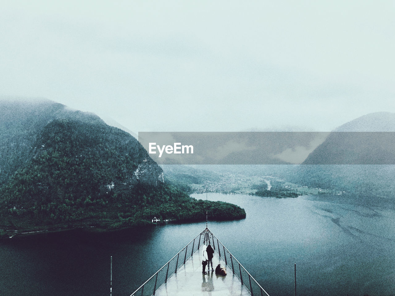 High angle view of people in ship on lake against sky during winter