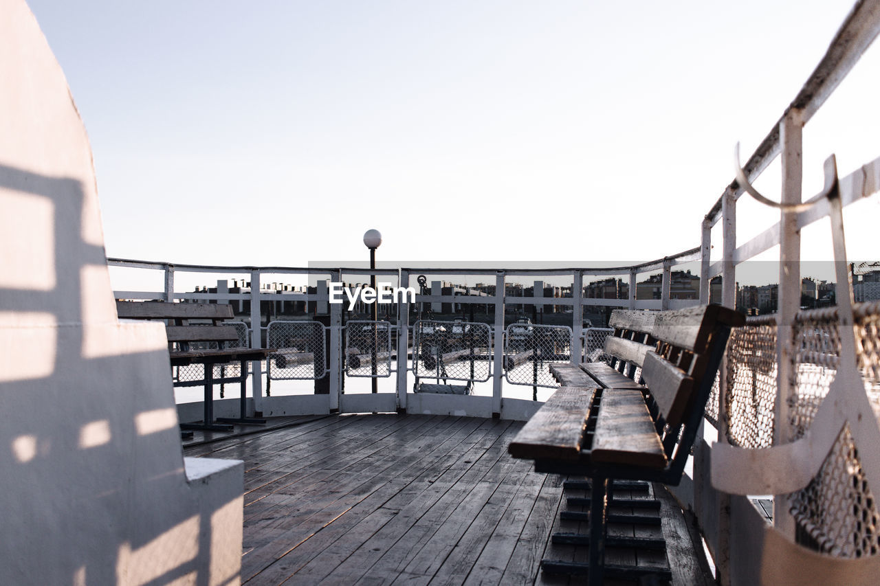 MAN RELAXING ON RAILING AGAINST BRIDGE