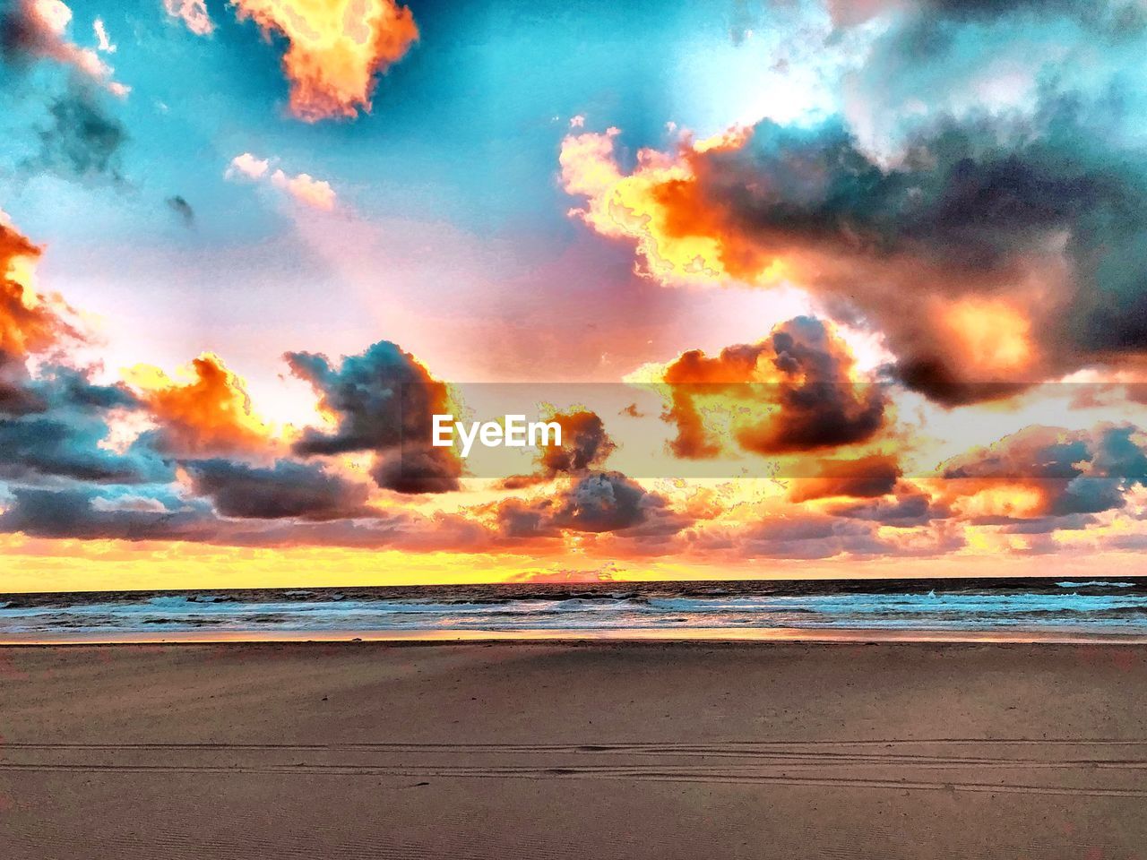 SCENIC VIEW OF BEACH AGAINST SKY AT SUNSET