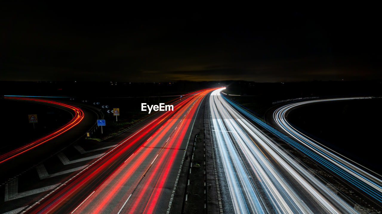 High angle view of light trails on highway at night