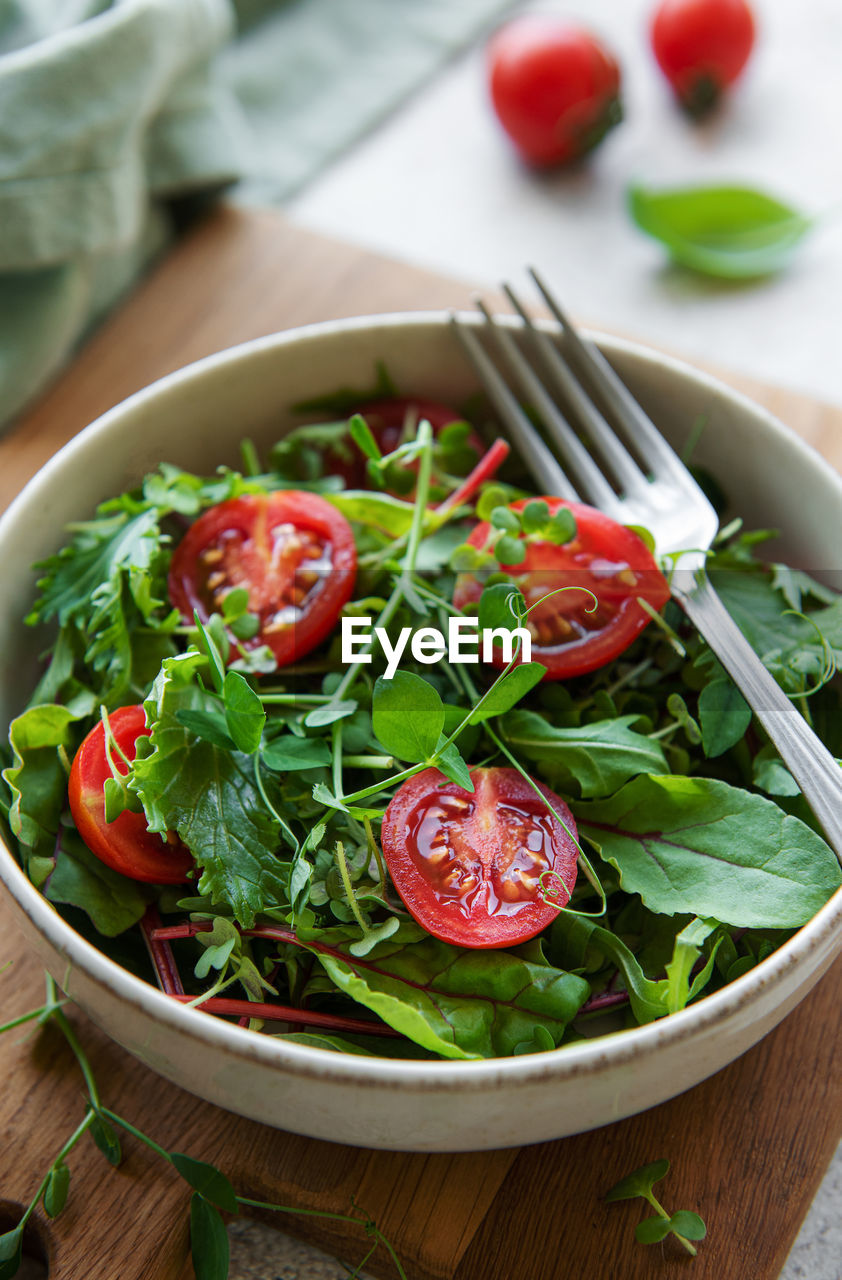 Vegan food healthy fresh vegetables salad. salad with arugula and cherry tomatoes.