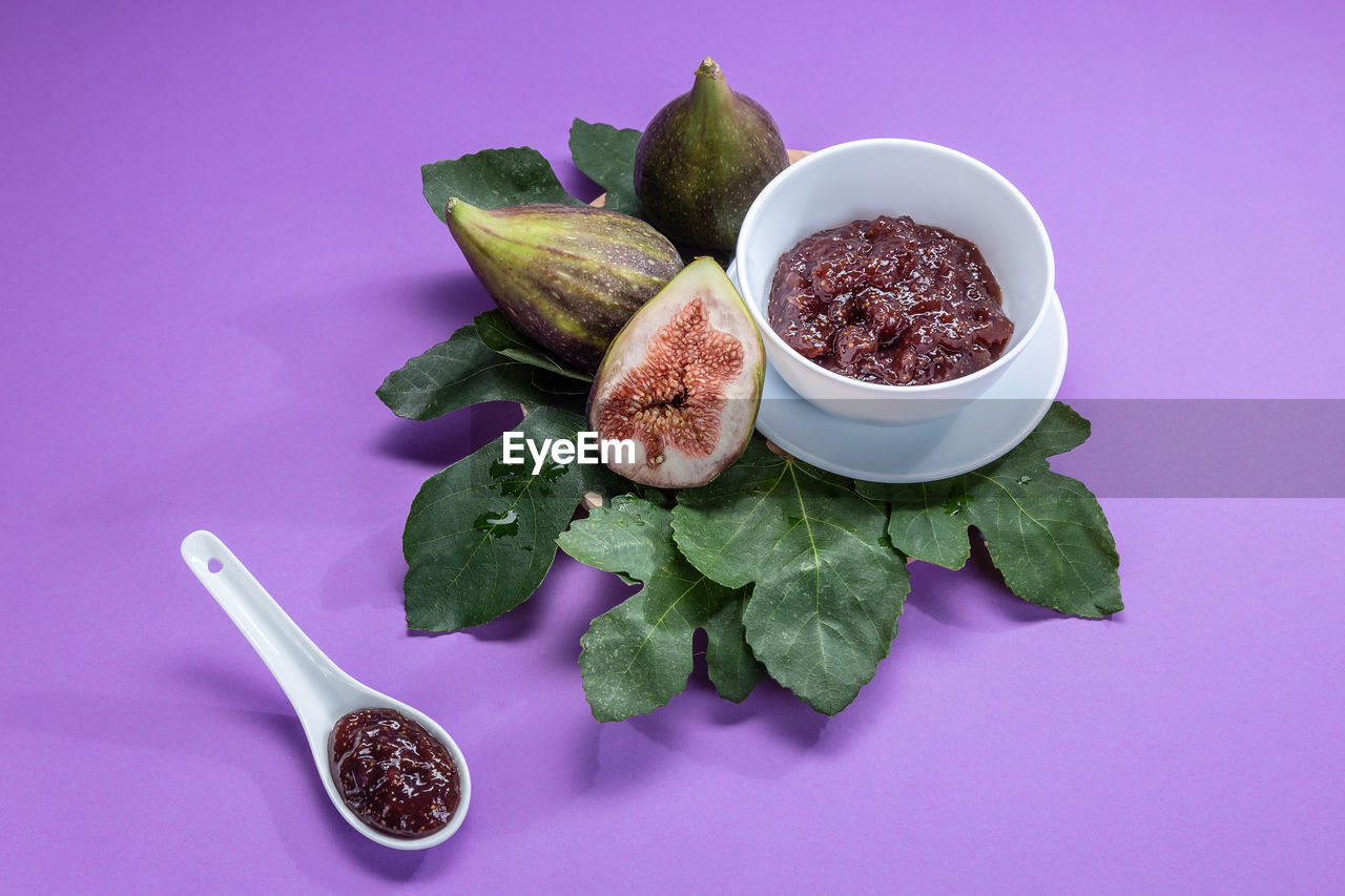 food and drink, food, healthy eating, wellbeing, freshness, studio shot, colored background, vegetable, indoors, spoon, no people, purple, fruit, leaf, plant part, still life, kitchen utensil, high angle view, spice, bowl, flower, eating utensil, ingredient, produce, herb, plant, pink background, zucchini, variation