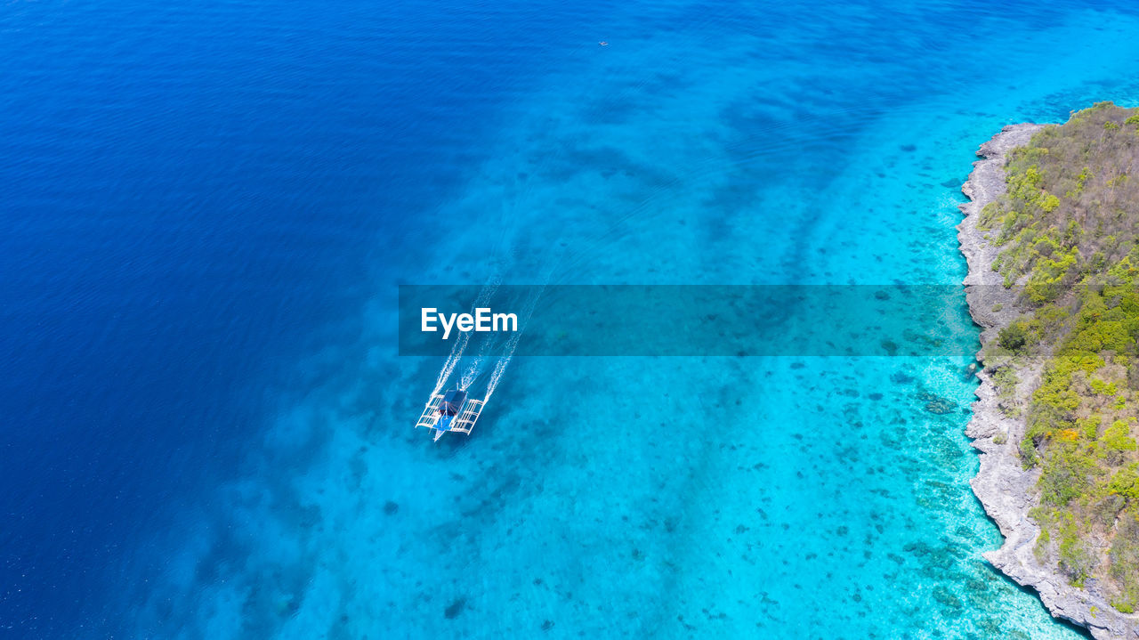 Aerial top down view of boat moving in open sea,  moalboal, oslob, cebu island, philippines.