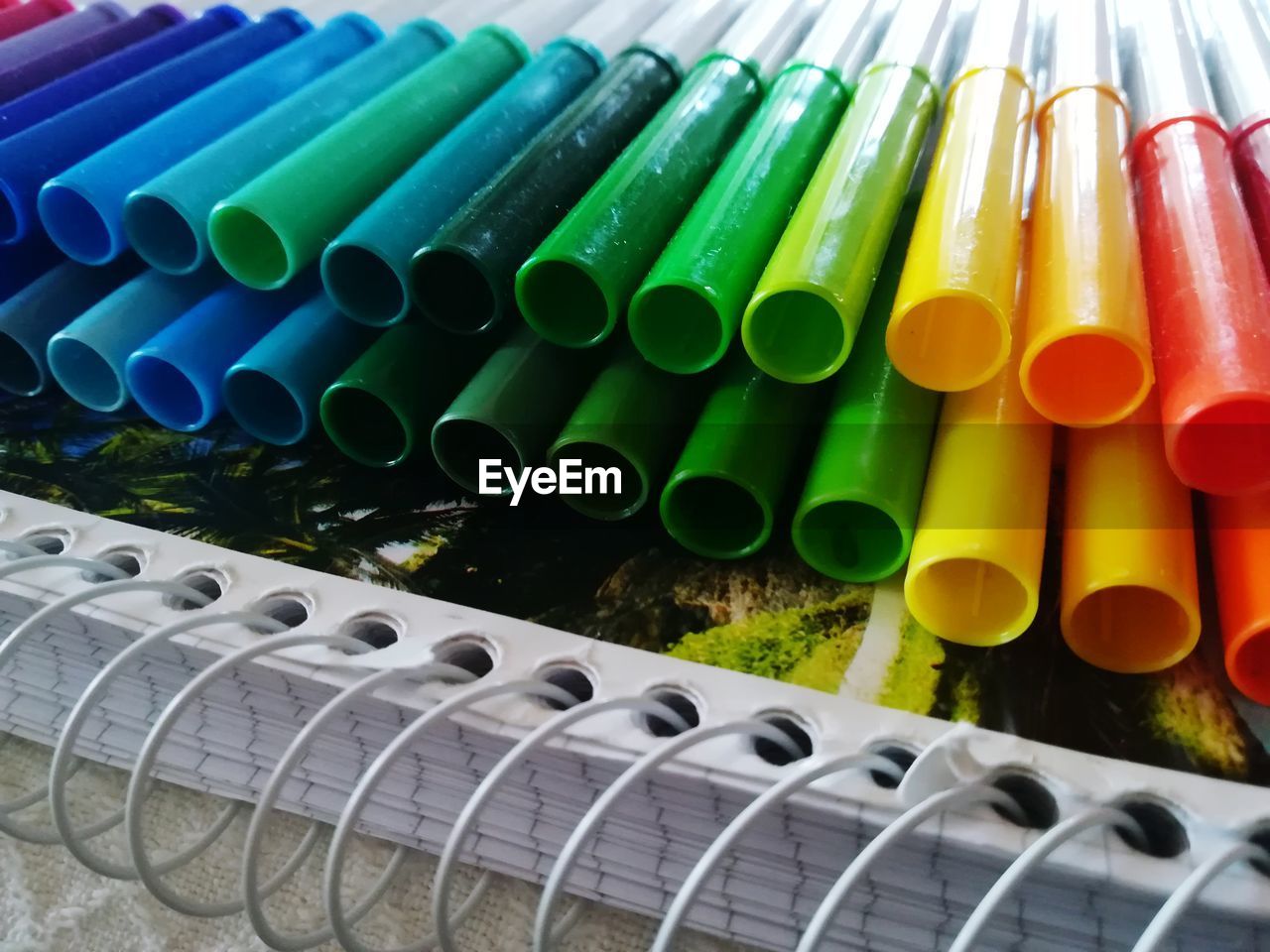 CLOSE-UP OF MULTI COLORED PENCILS IN CONTAINER