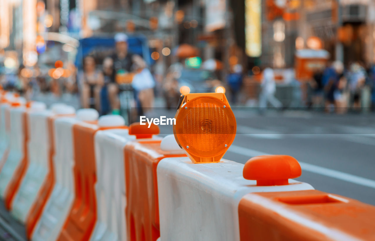 CLOSE-UP OF ORANGE BALLOON IN CITY