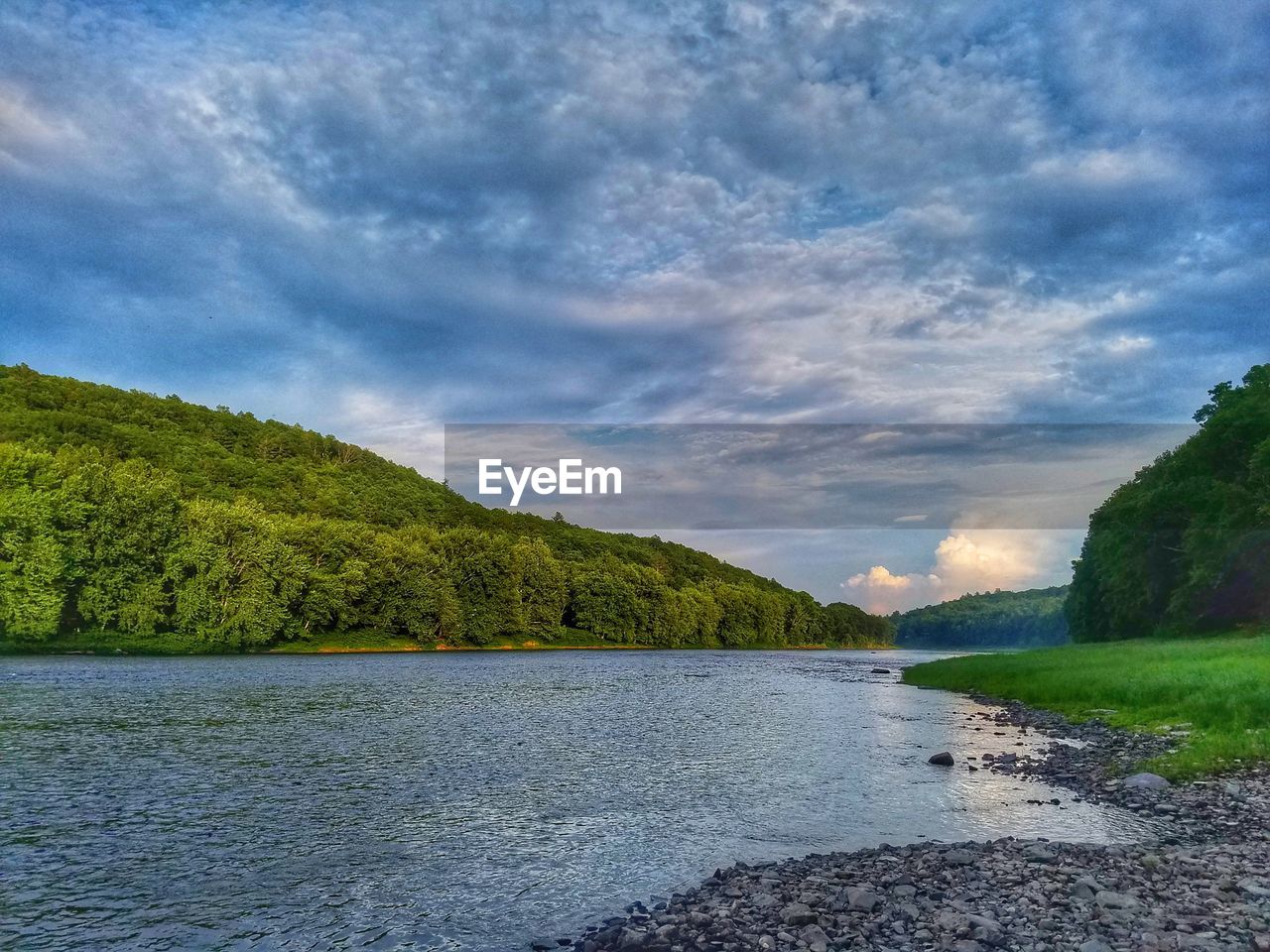 RIVER AMIDST TREES AGAINST SKY