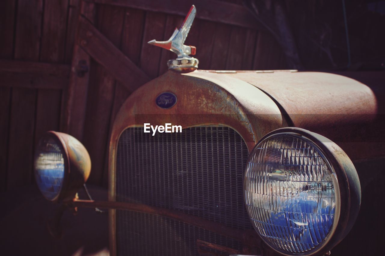 CLOSE-UP OF VINTAGE CAR AGAINST THE SKY