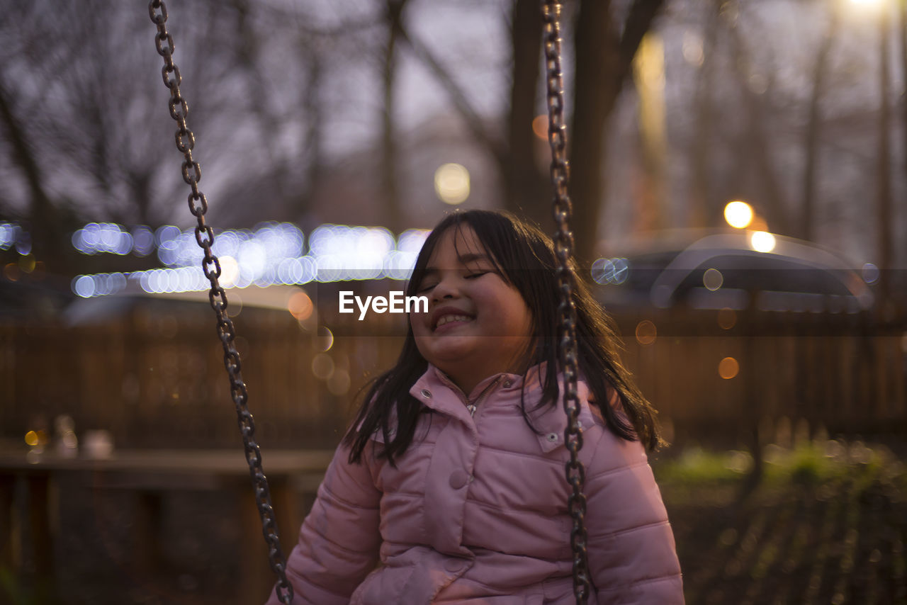 Girl on swing at dusk