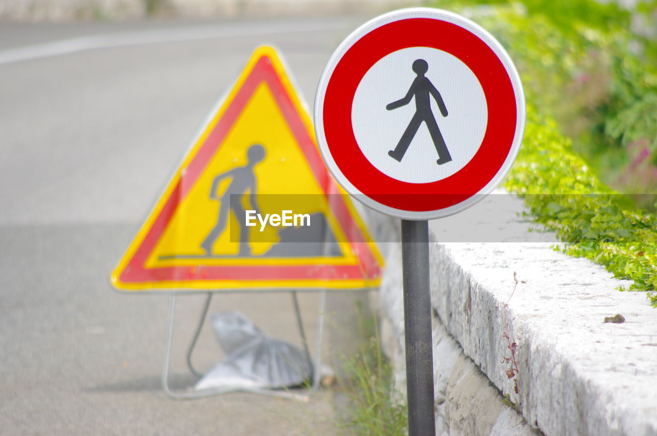 Pedestrian crossing sign on road