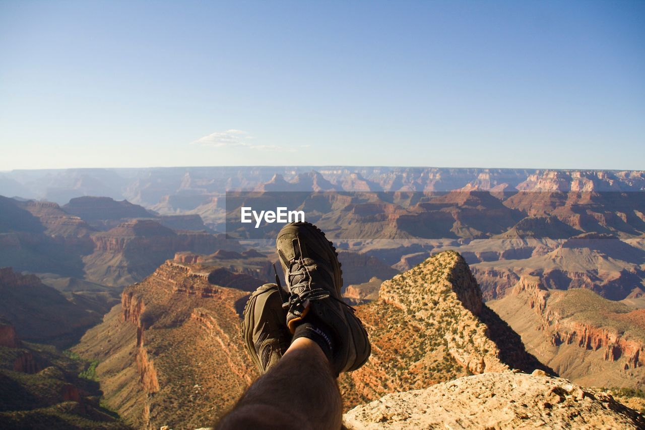 LOW SECTION OF MAN STANDING ON MOUNTAIN