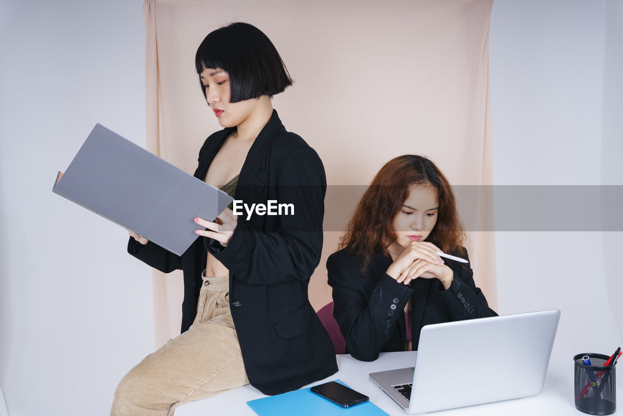 Lesbian couple working in office