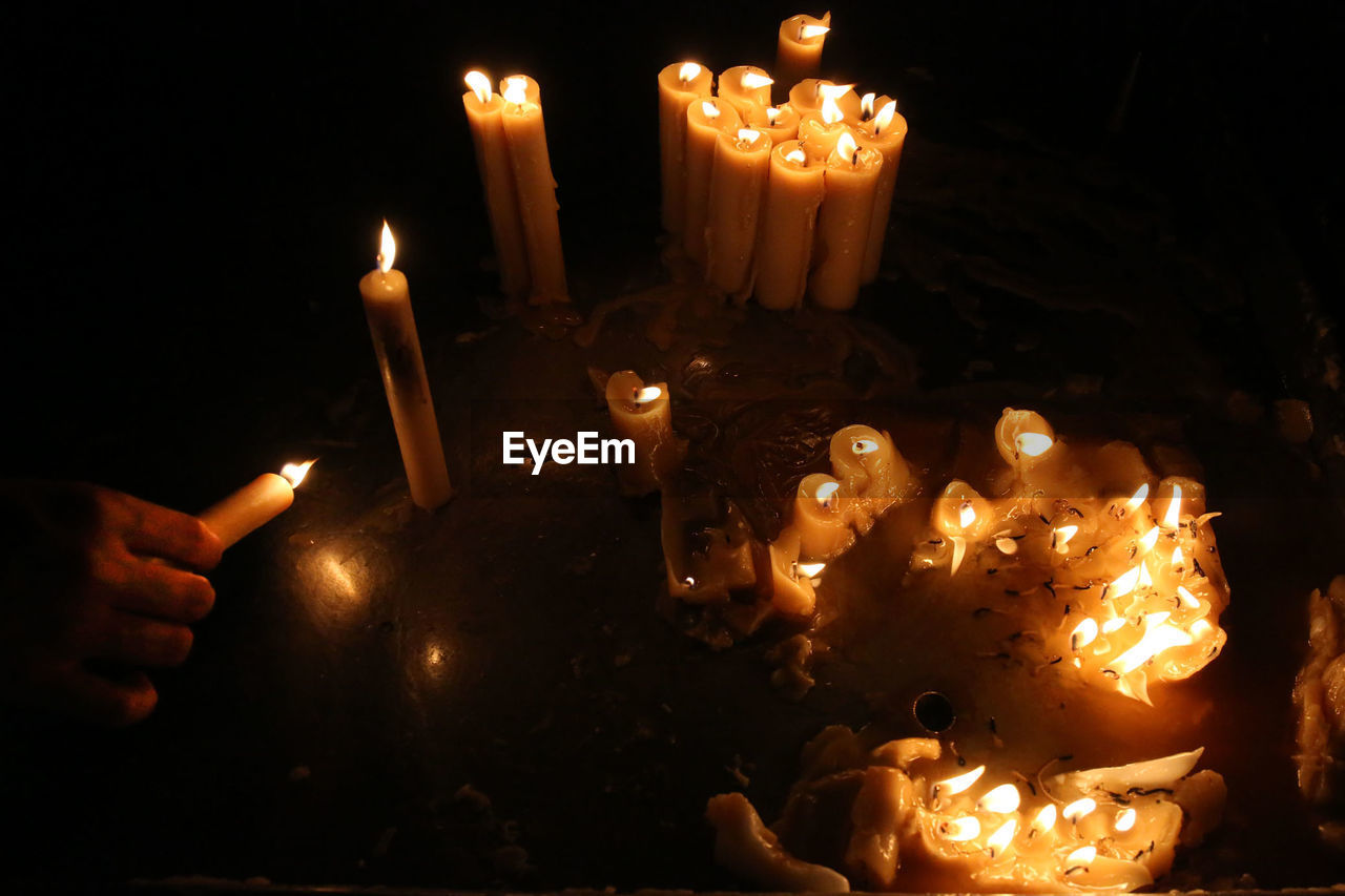 CLOSE-UP OF CANDLES BURNING