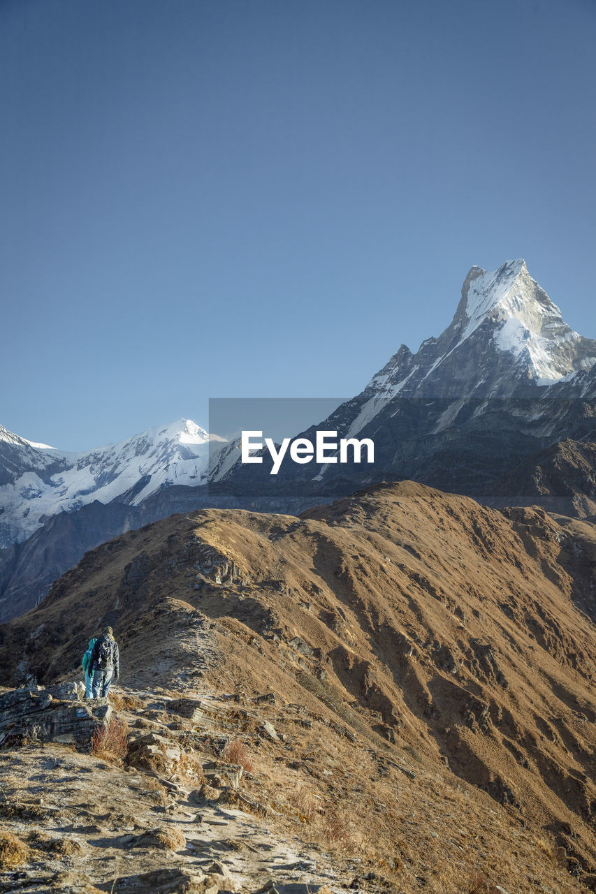 Scenic view of snowcapped mountains against clear sky