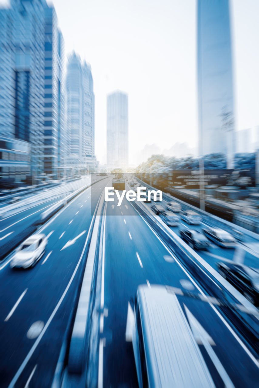 BLURRED MOTION OF ROAD IN CITY AGAINST BUILDINGS