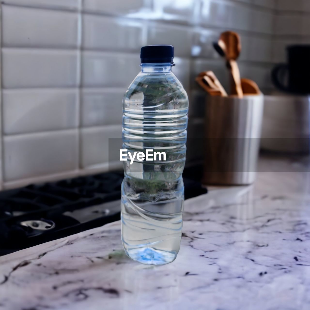 water, drinking water, bottle, mineral water, indoors, container, bottled water, glass, household equipment, blue, no people, food and drink, drinkware, drink, table, nature, domestic room, tableware, focus on foreground, close-up, water bottle, refreshment