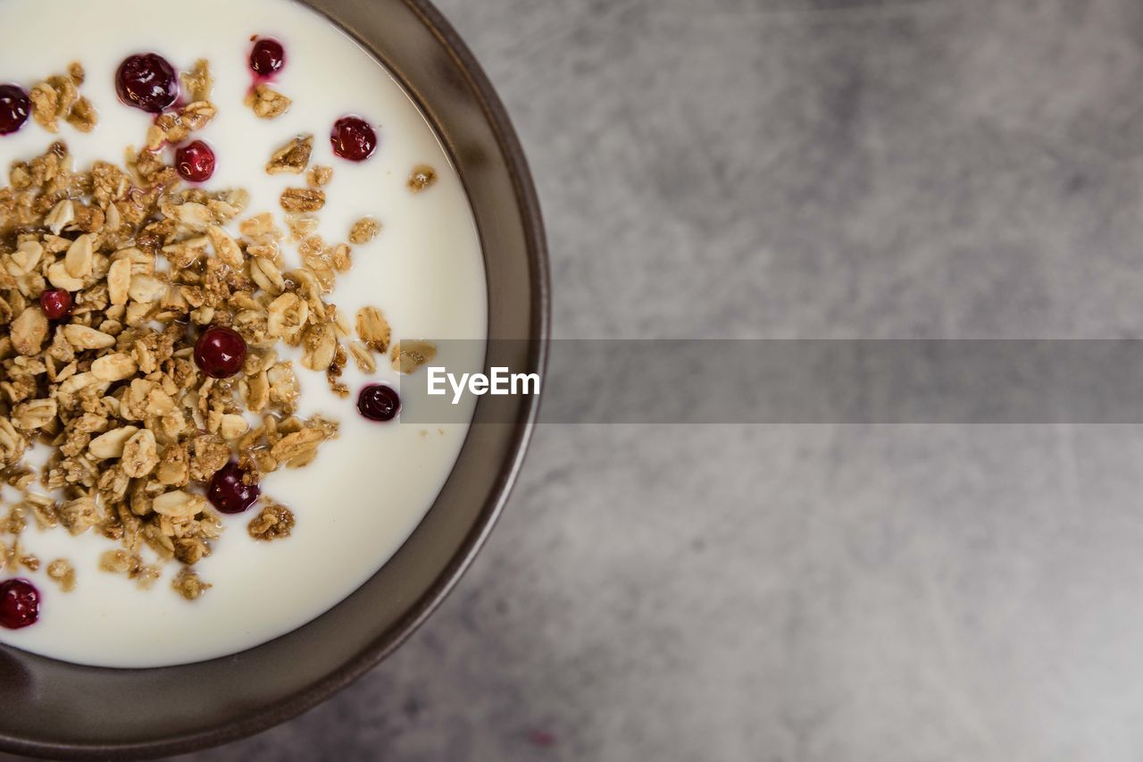 Healthy breakfast with muesli in banana yogurt top view