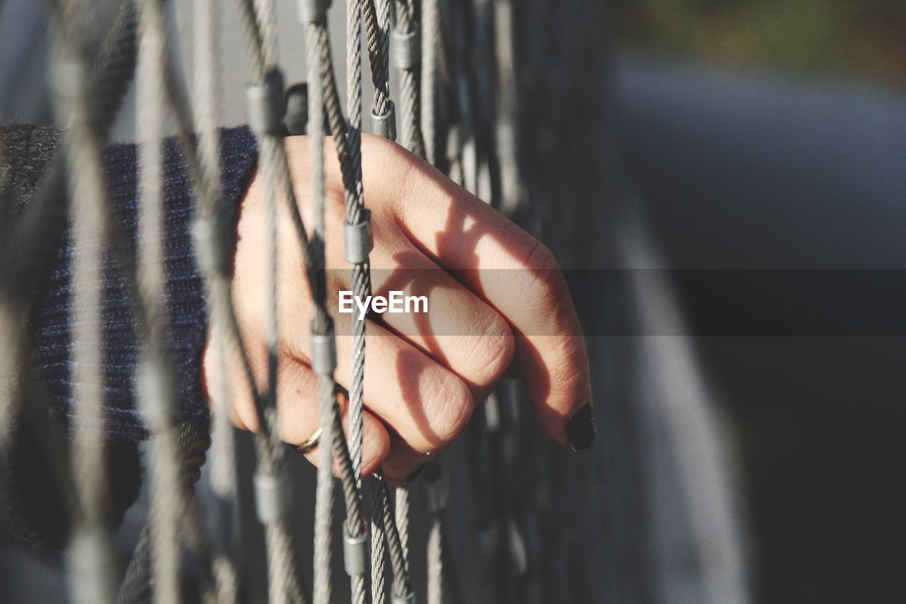 Close-up of hand in netting