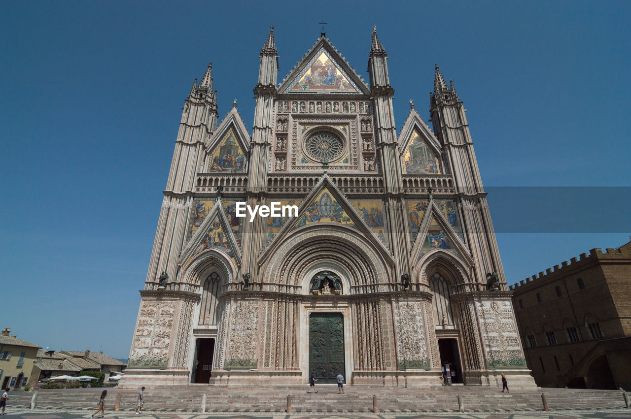 Low angle view of historical church building against blue sky