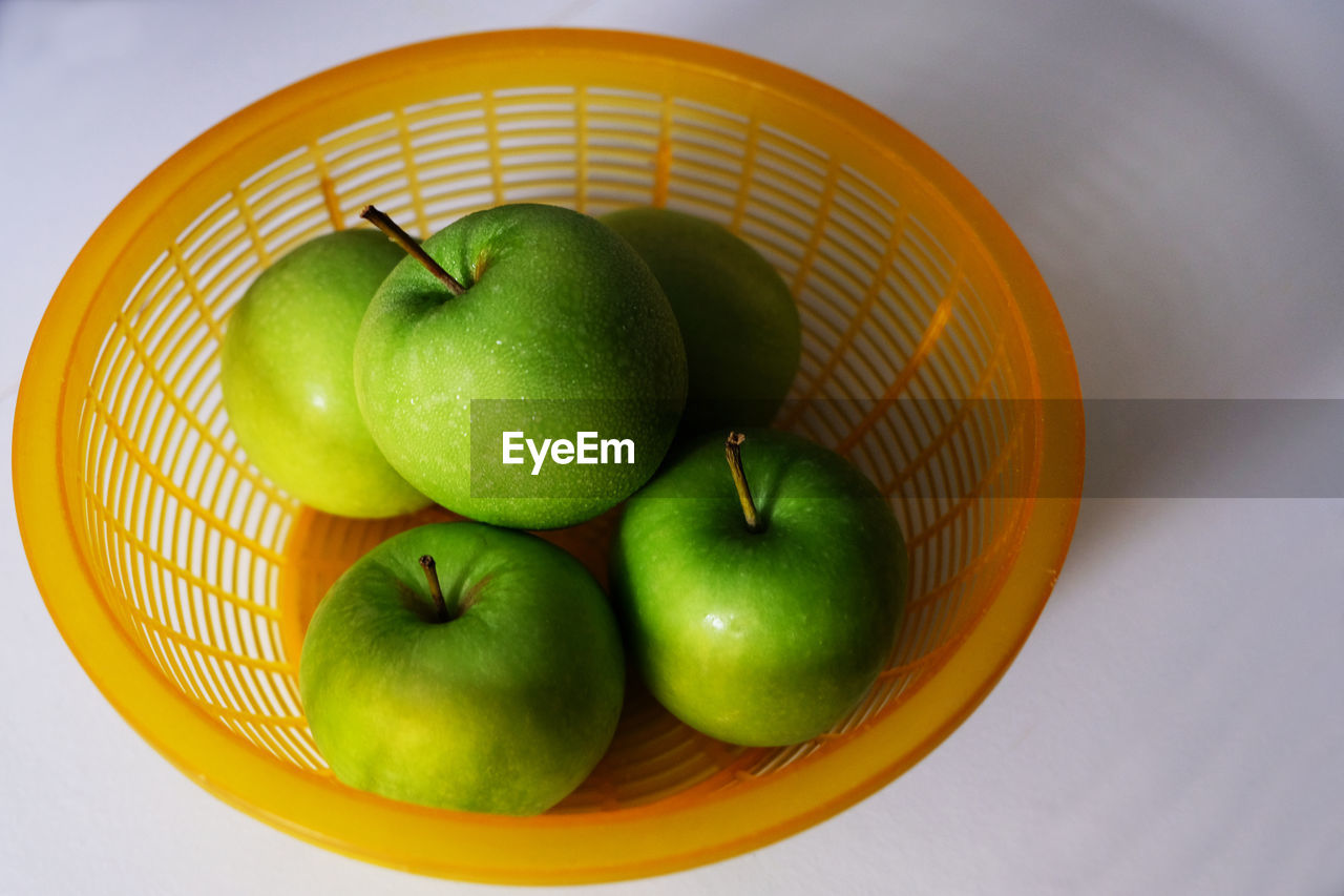 High angle view of apples in basket on table