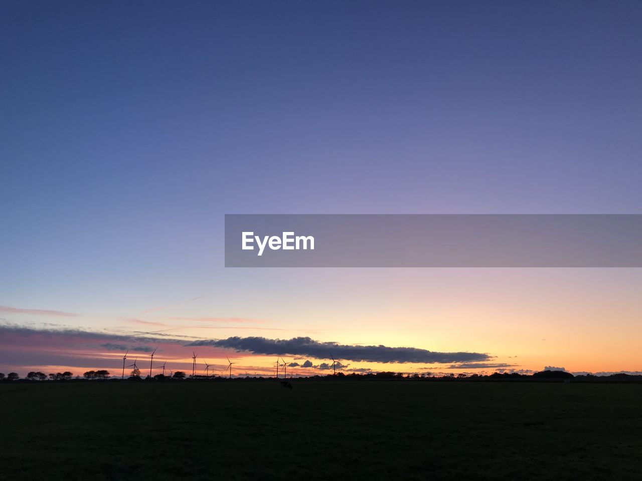 SCENIC VIEW OF FIELD AGAINST CLEAR SKY DURING SUNSET