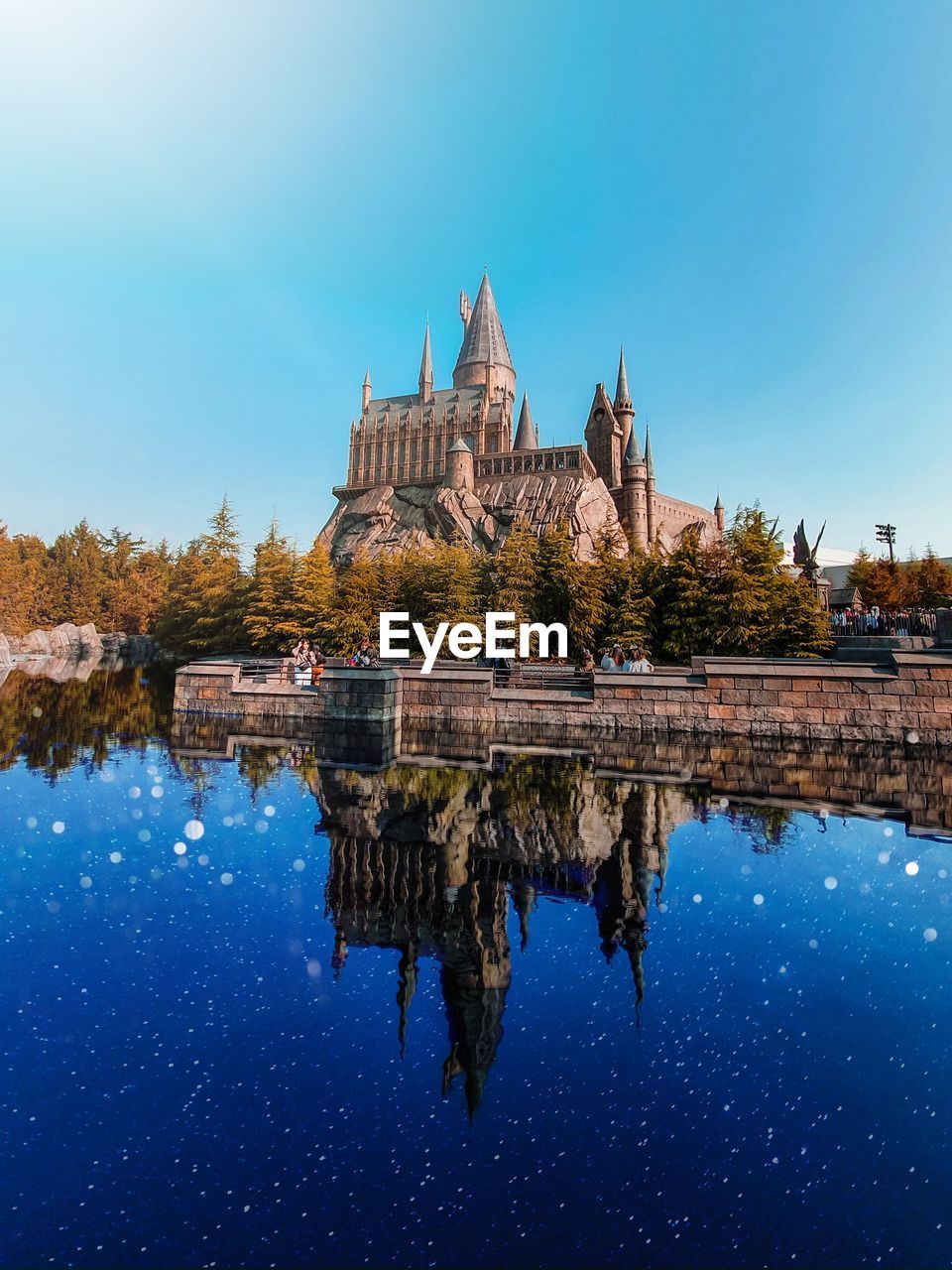 Reflection of castle in water against sky