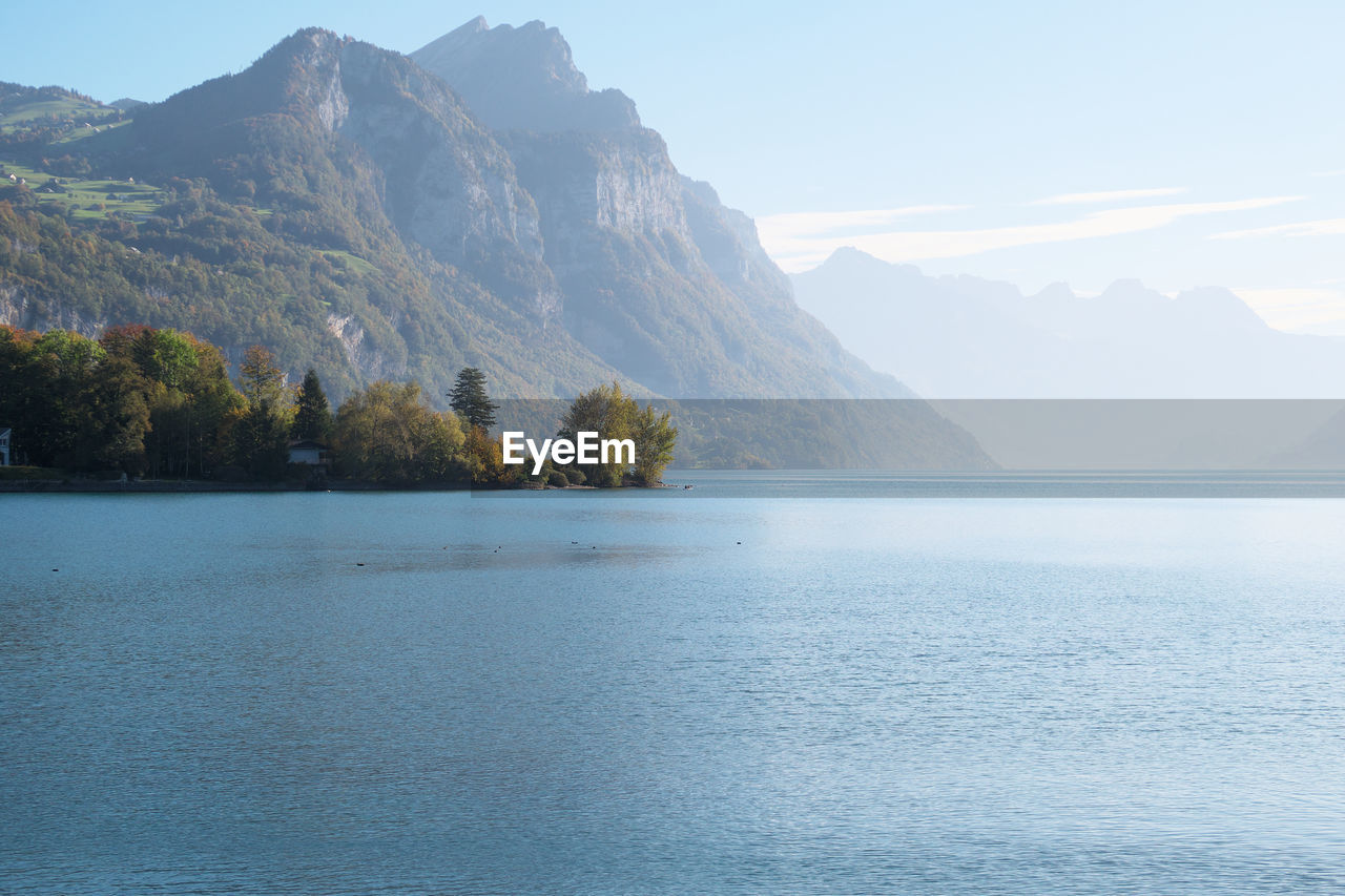 SCENIC VIEW OF LAKE AGAINST MOUNTAIN RANGE