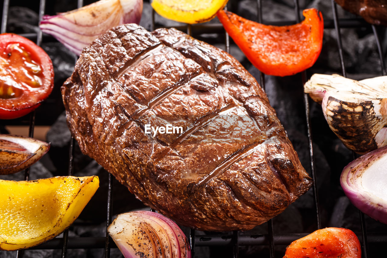 Juice beef steak on a barbecue grill with vegetables