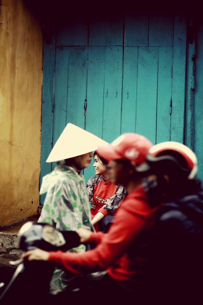 REAR VIEW OF PEOPLE IN TRADITIONAL BUILDING