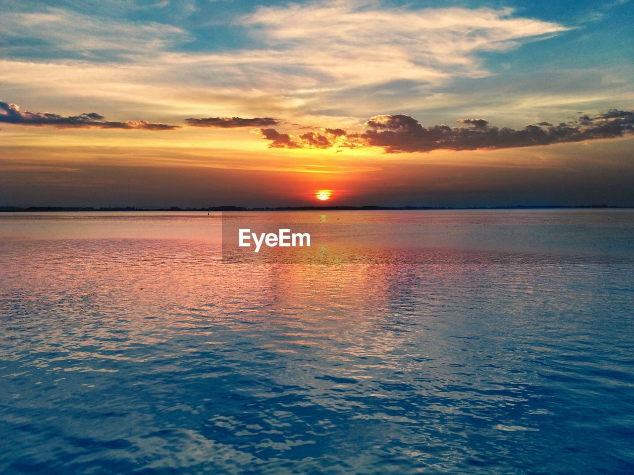 Scenic view of lake against sky during sunset