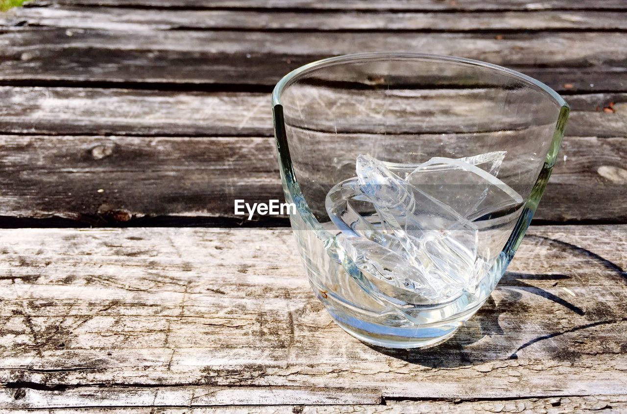 Broken glass on wooden table