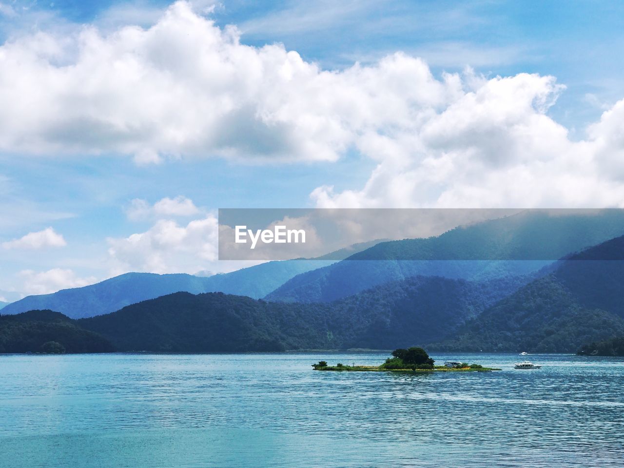 Scenic view of sea and mountains against sky