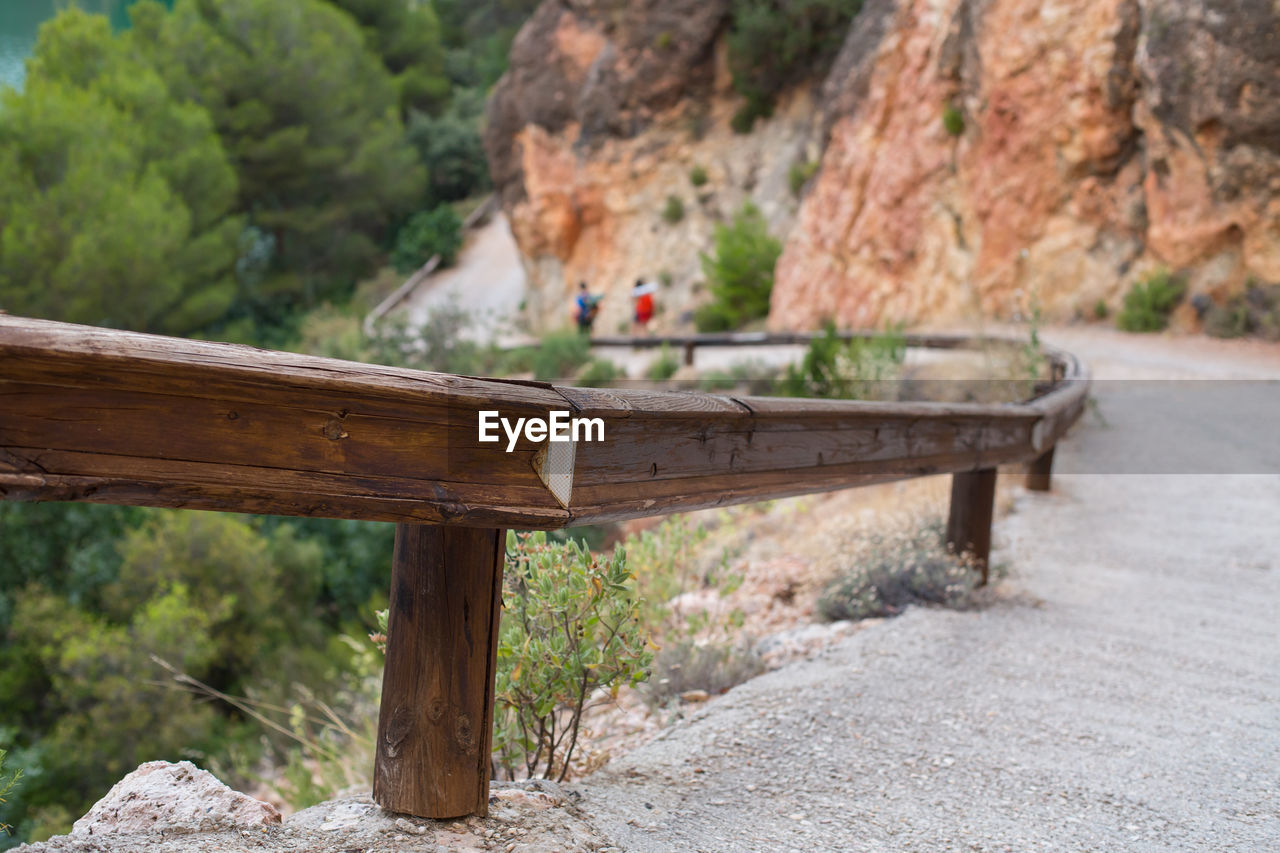 BENCH ON ROCK AGAINST TREES